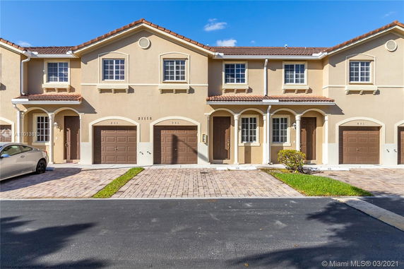 Front view of a two-story townhouse with attached garages.