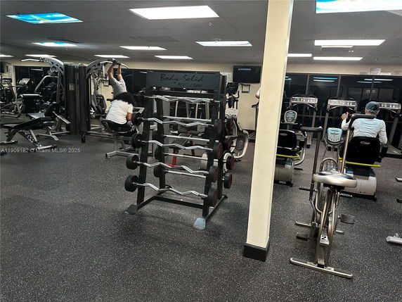 Interior view of a fitness gym with various exercise equipment.