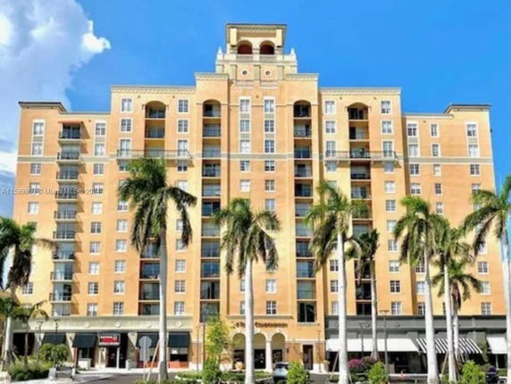 Front view of a multi-story residential building with balconies.