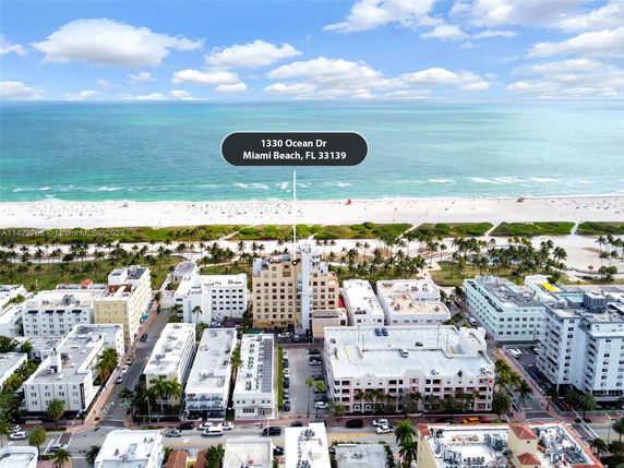 Aerial view of a coastal area with buildings and a beach.