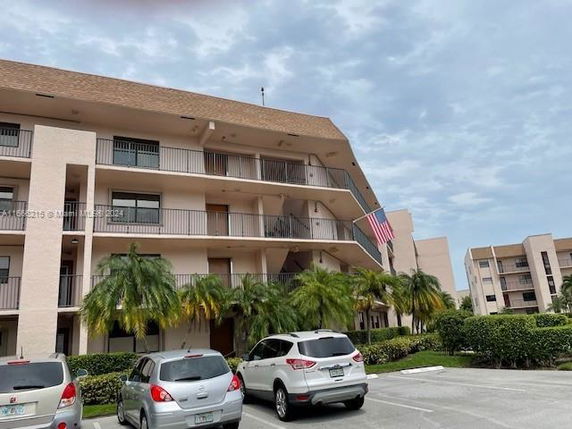 Front view of a multi-story apartment building with balconies.