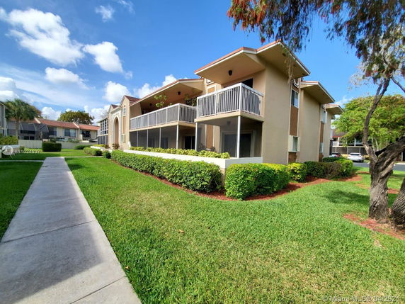 Front view of a multi-story apartment building with balconies.