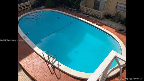 Outdoor swimming pool with surrounding patio area.