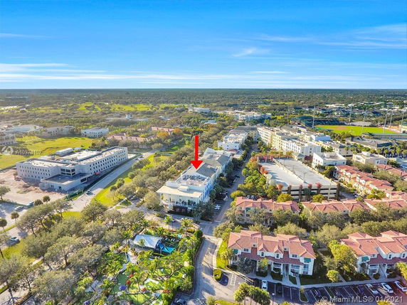 Panoramic view of a residential and commercial area with multiple buildings and green spaces.