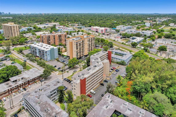 Aerial view of urban residential buildings with surrounding greenery.