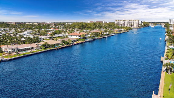 Aerial view of waterfront properties alongside a canal.