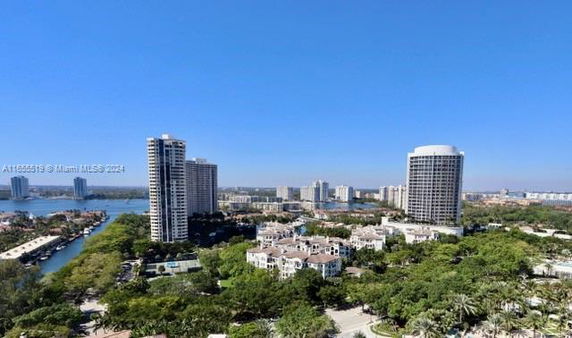 Panoramic view of buildings and greenery from a high vantage point.