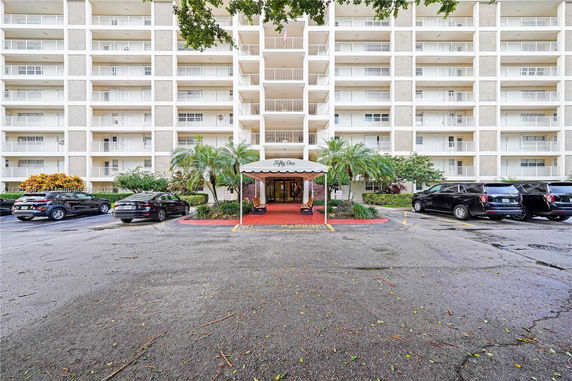 Front view of a multi-story residential building with balconies.