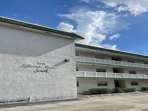 Front view of a multi-story building with balconies.