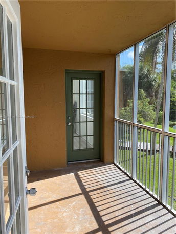 View from a balcony with a green door and metal railings.