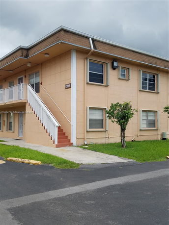Front view of a two-story building with exterior stairs.