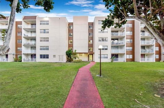 Front view of a multi-story residential building with balconies.