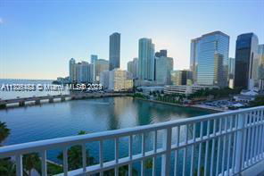 Panoramic view of a city skyline with multiple tall buildings next to a body of water.