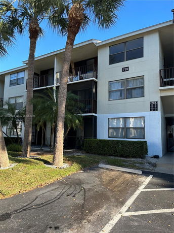 Front view of a three-story apartment building with balconies.