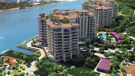 Aerial view of multi-story residential buildings with water and landscaped gardens.