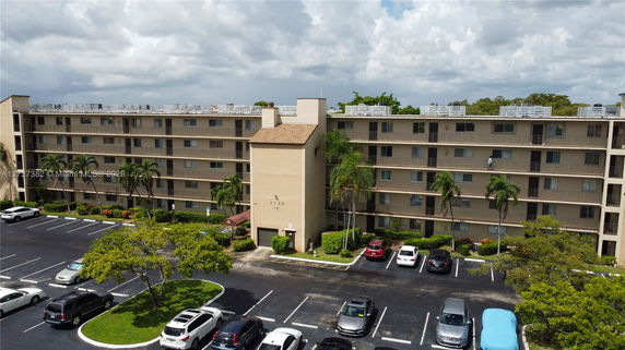 Front view of a multi-story residential building with balconies.