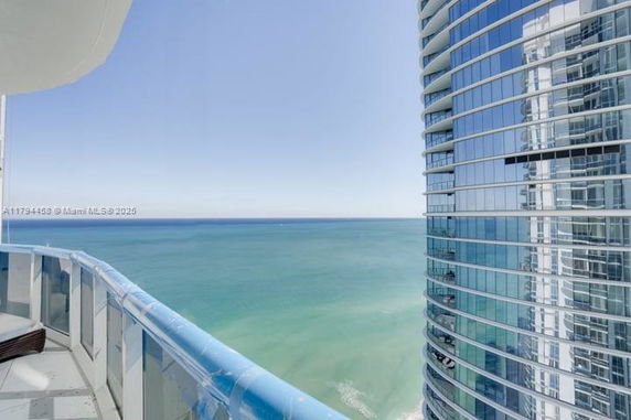 Panoramic view of ocean from high-rise building balcony.