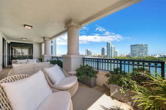 Covered outdoor seating area with panoramic city and water view.
