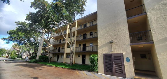 Front view of a multi-story residential building with balconies.