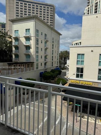 Urban area with multiple multi-story buildings and a sushi restaurant