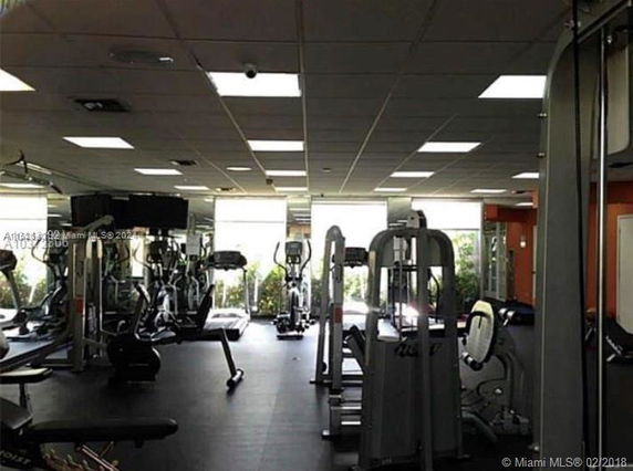 Interior view of a gym with various exercise equipment.