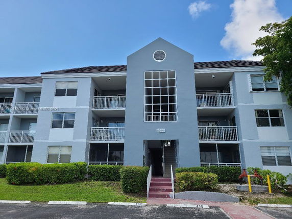 Front view of a three-story residential building with balconies.