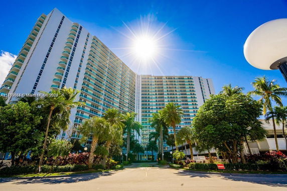 Front view of a multi-story residential building with balconies.