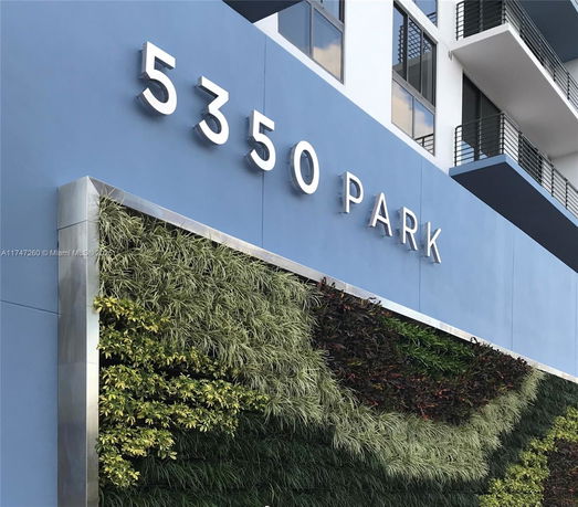 Front view of a building with a vertical garden and large signage displaying '5350 Park'.