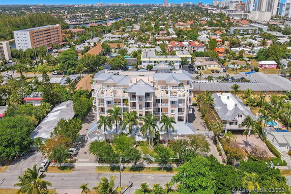 View of a multi-story residential building surrounded by other buildings in a suburban area.