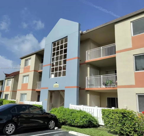 Front view of a multi-story residential building with balconies.