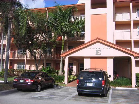 Front view of a multi-story building with a covered entrance.