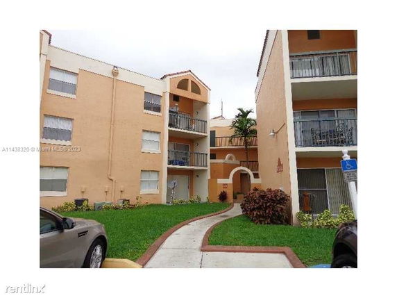Front view of a multi-story apartment building with balconies.