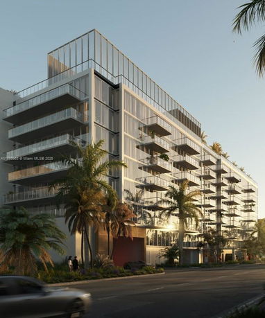 Front view of a multi-story modern building with balconies.