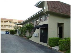 Front view of a two-story building with an awning over the entrance.