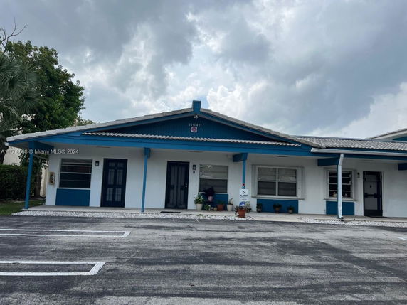 Front view of a single-story building with a blue and white exterior.