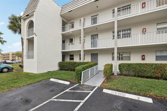 Front view of a multi-story residential building with balconies.