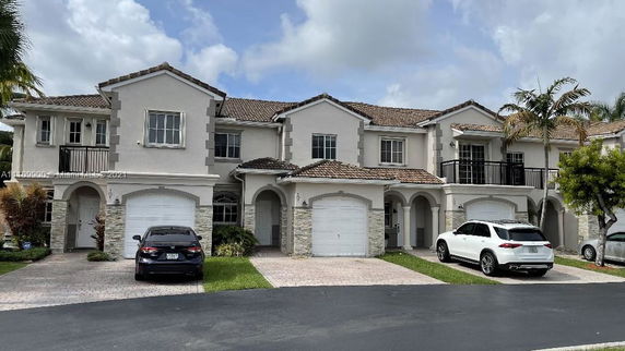Front view of a multi-story house with attached garages.