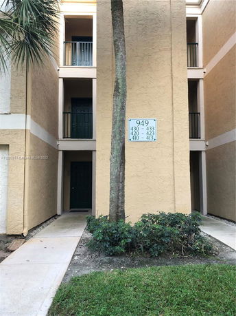 View of a multi-level apartment entrance with balconies.