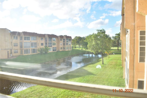 View of apartment buildings and a small water body seen from a window.