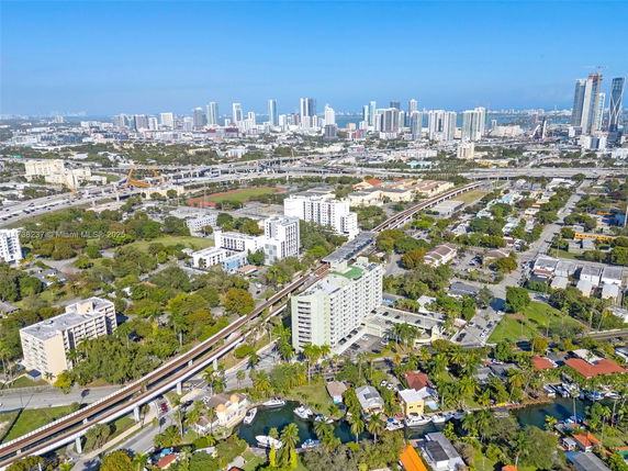 Panoramic view of a cityscape with various buildings, roads, and greenery.