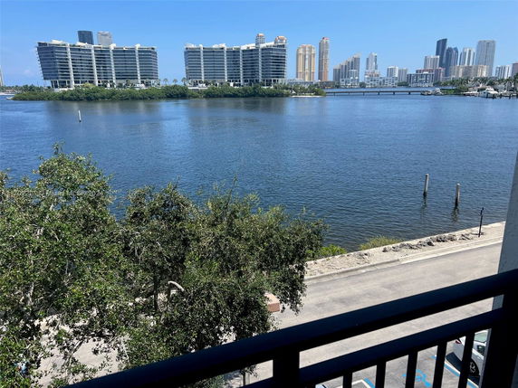 View of buildings and water body from a balcony.