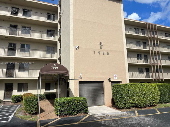 Front view of a multi-story residential building with balconies.