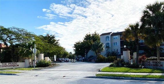 Front view of a multi-story condominium complex named The Prado.