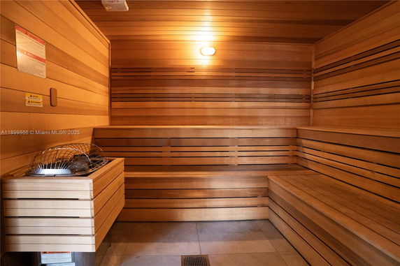 Room with wooden benches and a heat source, typical of a sauna.