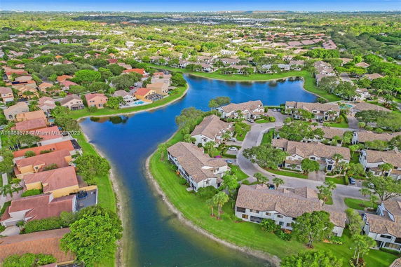 Aerial view of a residential area with houses surrounded by water bodies.