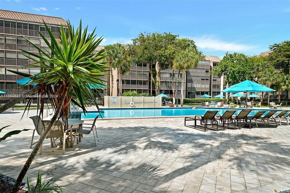 View of a pool area with a nearby apartment building.