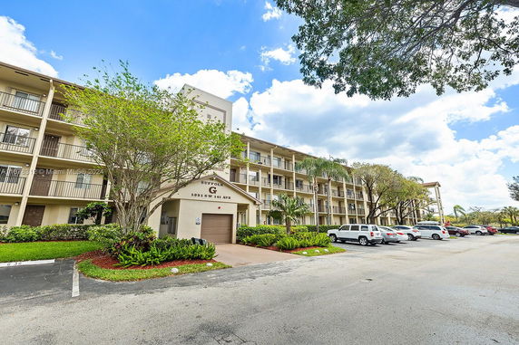 Front view of a multi-story residential building with balconies.