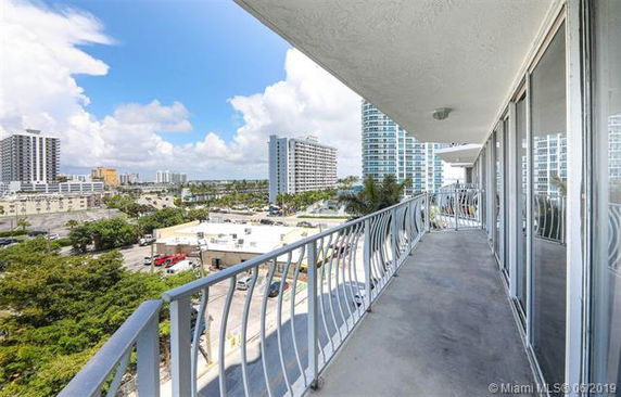Balcony view overlooking urban buildings and cityscape.