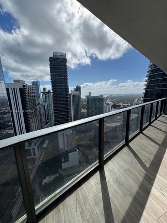View from a high-rise building balcony overlooking the city skyline.