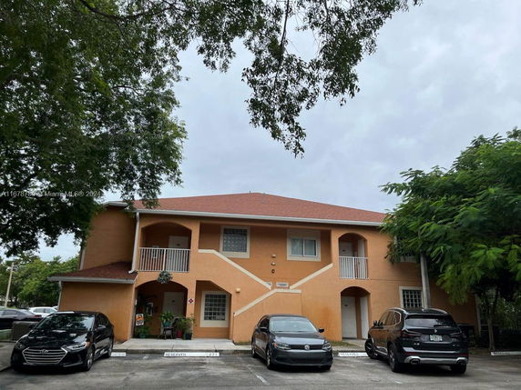Front view of a two-story building with balconies.